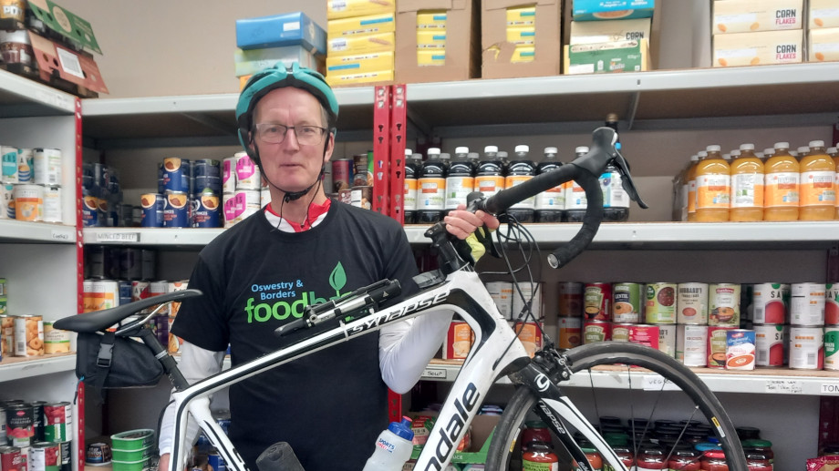 Duncan Kerr with bike inside the food bank