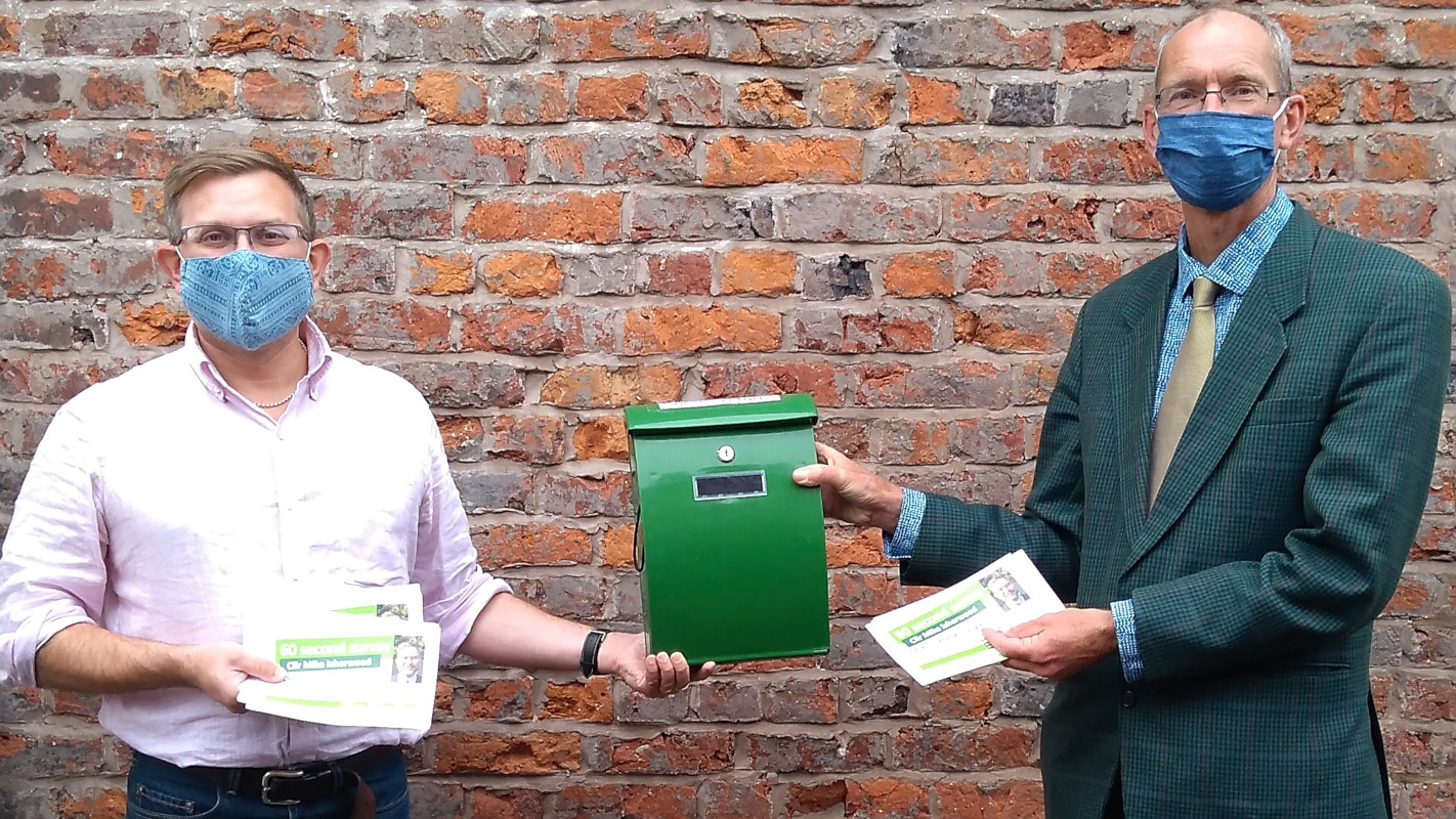 Oswestry Councillor Mike Isherwood and Duncan Kerr show the 60-second survey forms and collection box